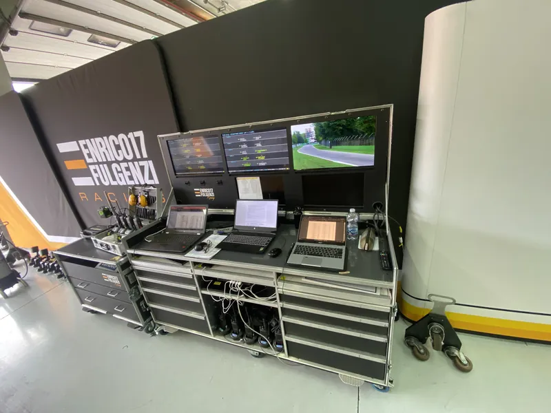Team engineering station with laptops and screens in the pit box