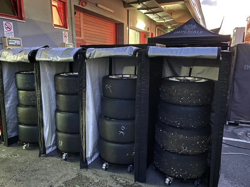 Tyre sets on racks in the pit lane