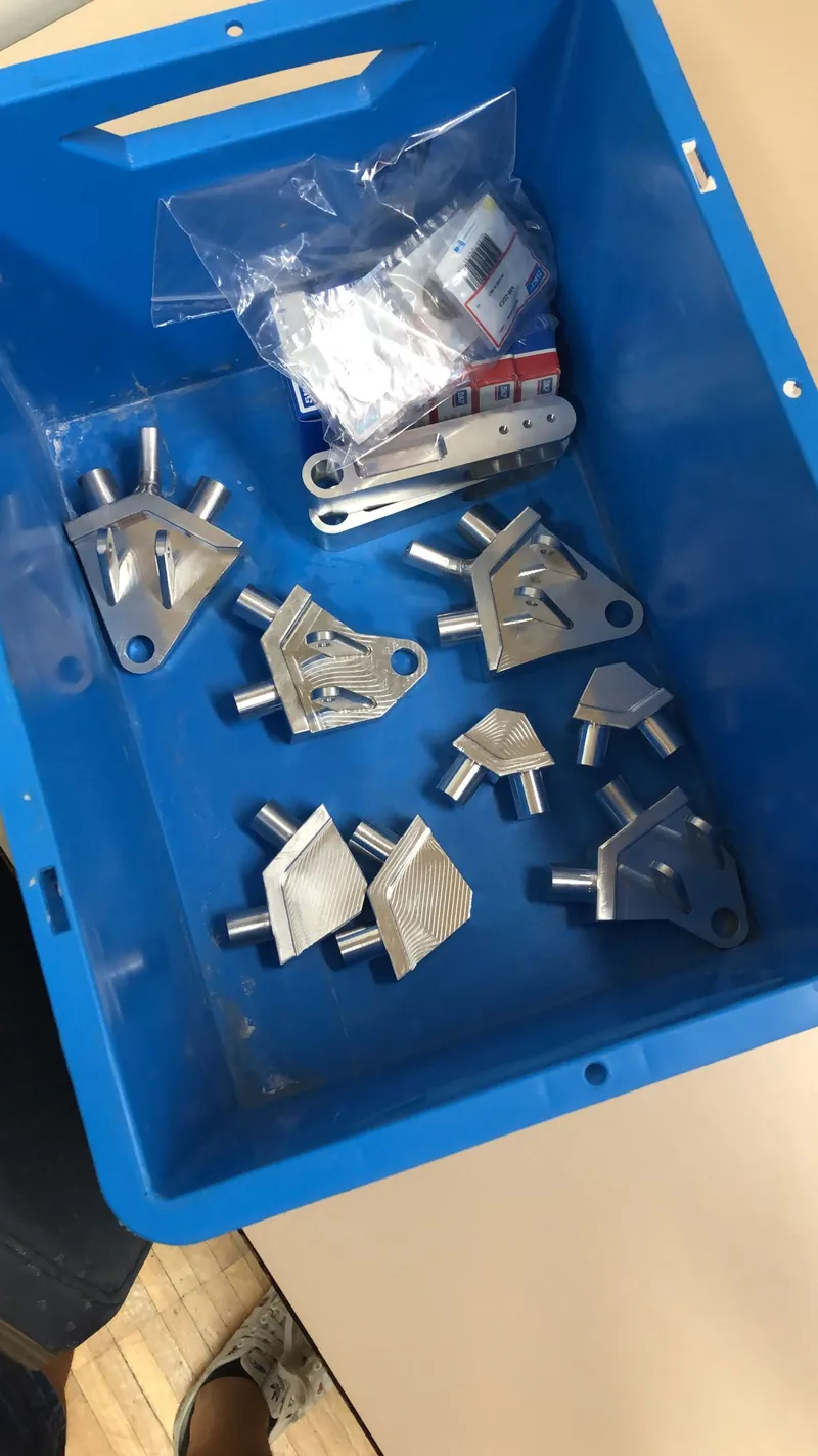 Machined suspension brackets in a storage box