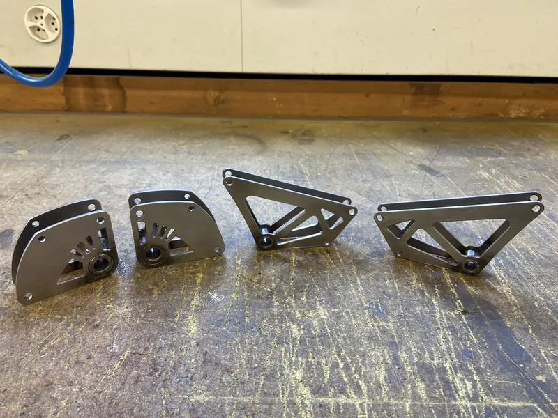 Machined aluminium parts laid out on a workbench